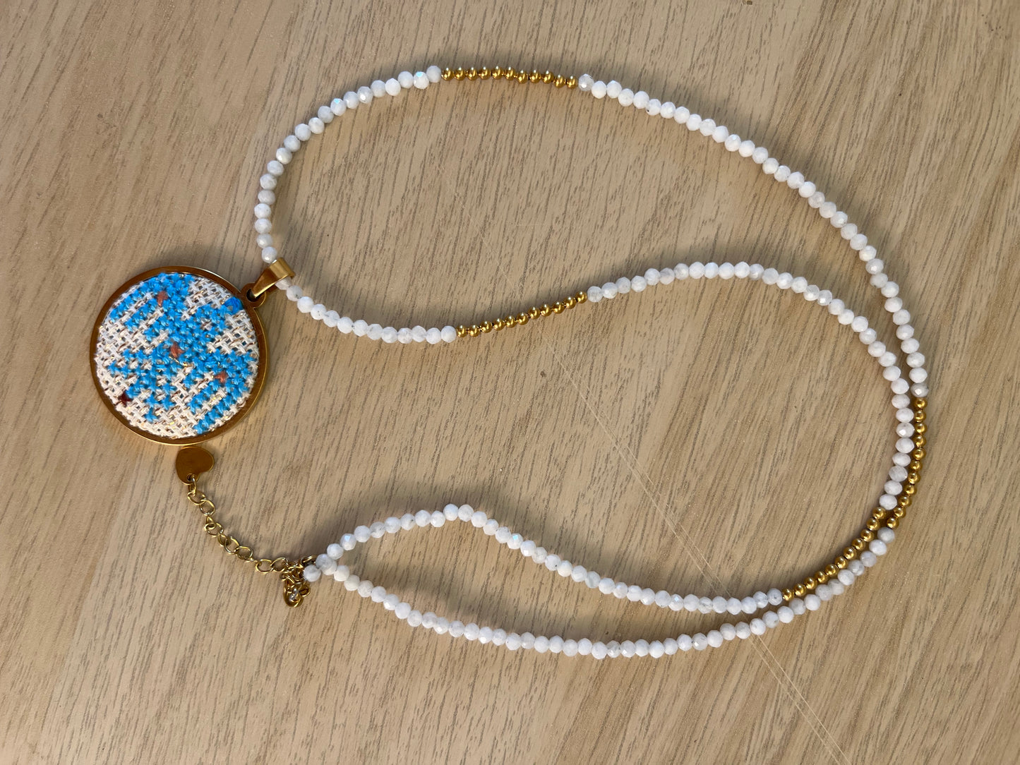 Hand embroidered cross stitch ancient bird pendant and moonstone necklace
