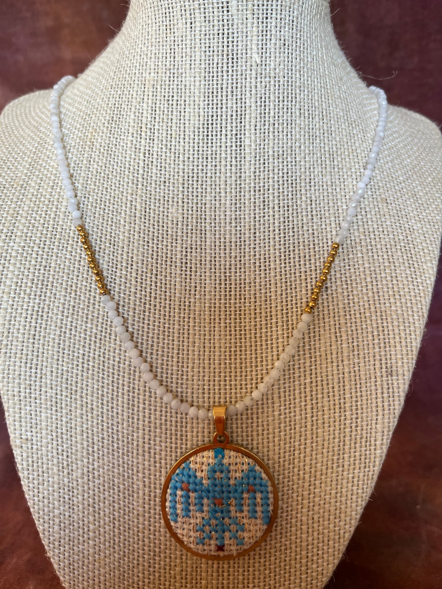 Hand embroidered cross stitch ancient bird pendant and moonstone necklace