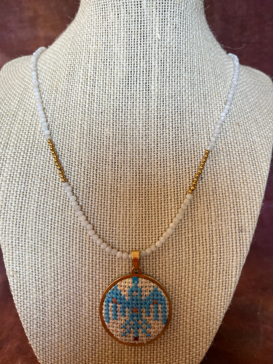Hand embroidered cross stitch ancient bird pendant and moonstone necklace