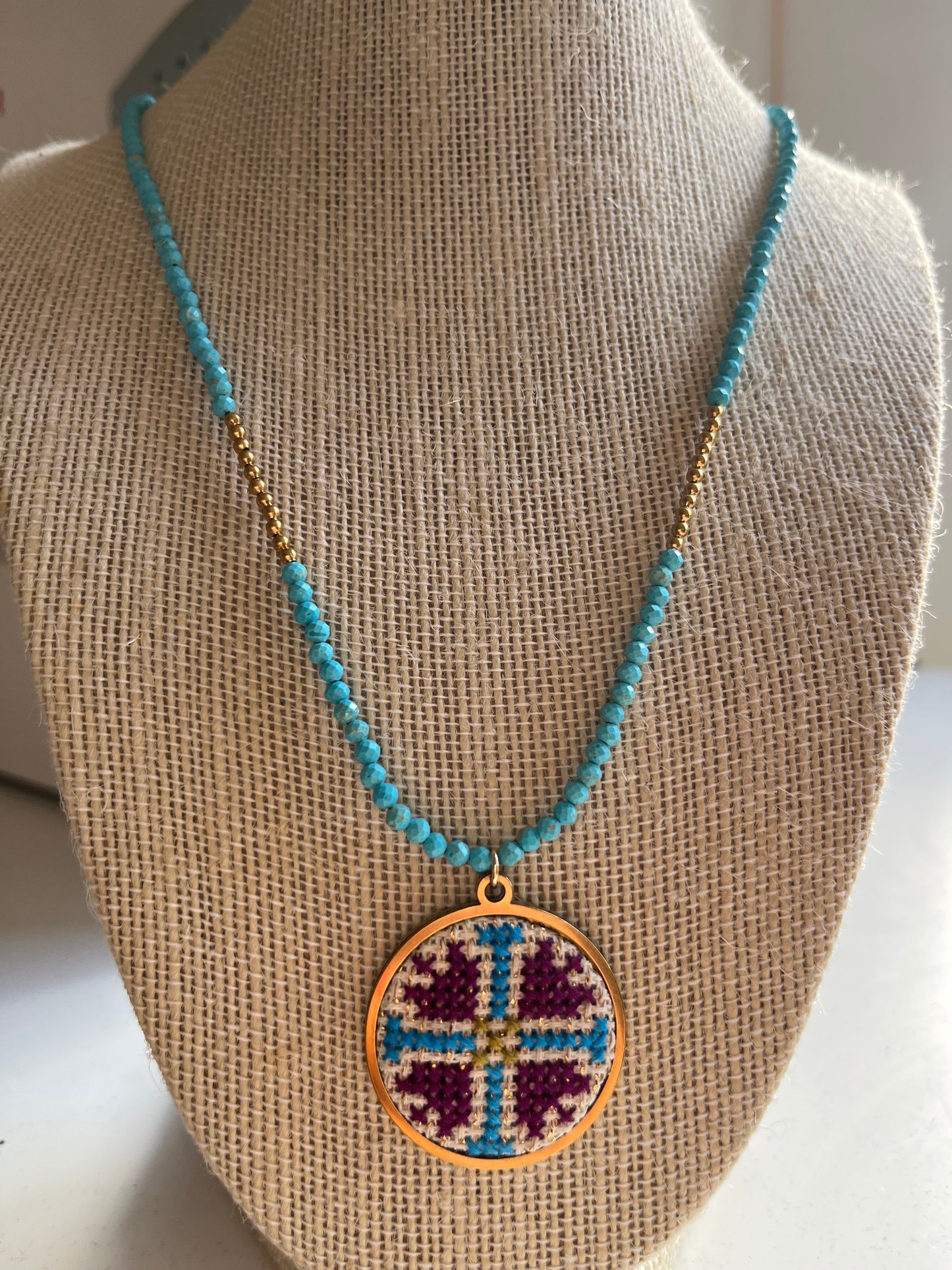 Hand embroidered cross stitch pendant and turquoise necklace