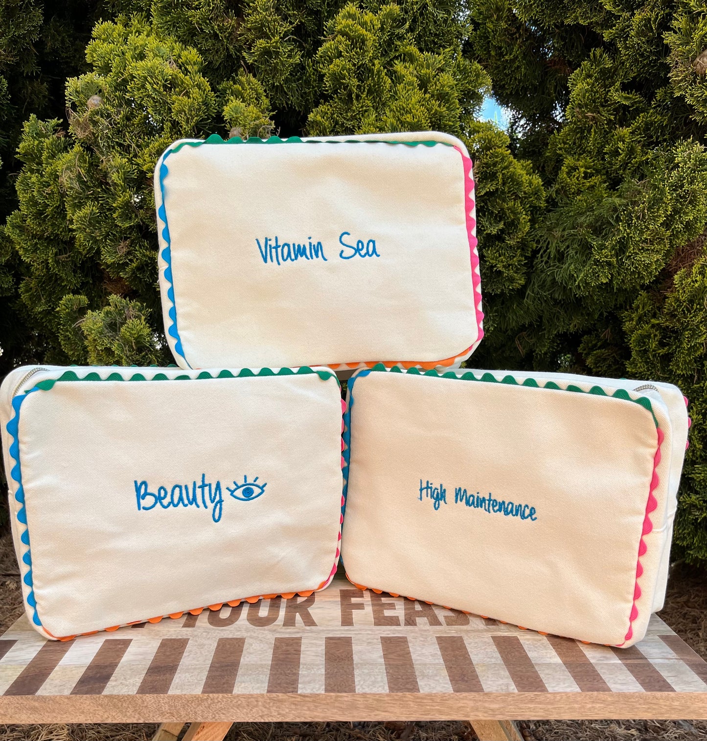 Embroidered canvas cosmetic bag with ric-rac border