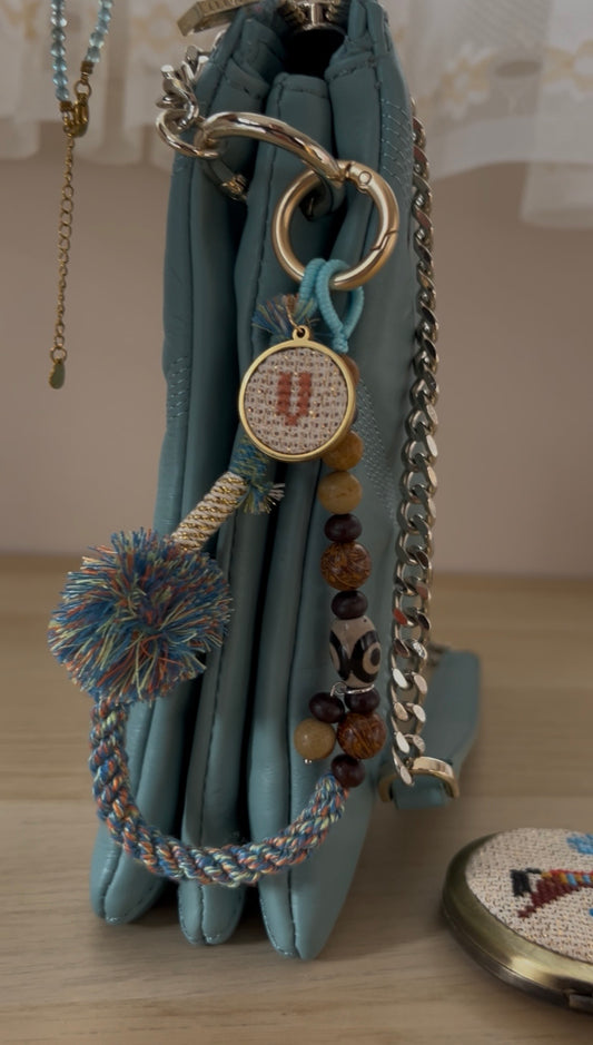 Beaded bag and phone charm with hand embroidered personalisation.