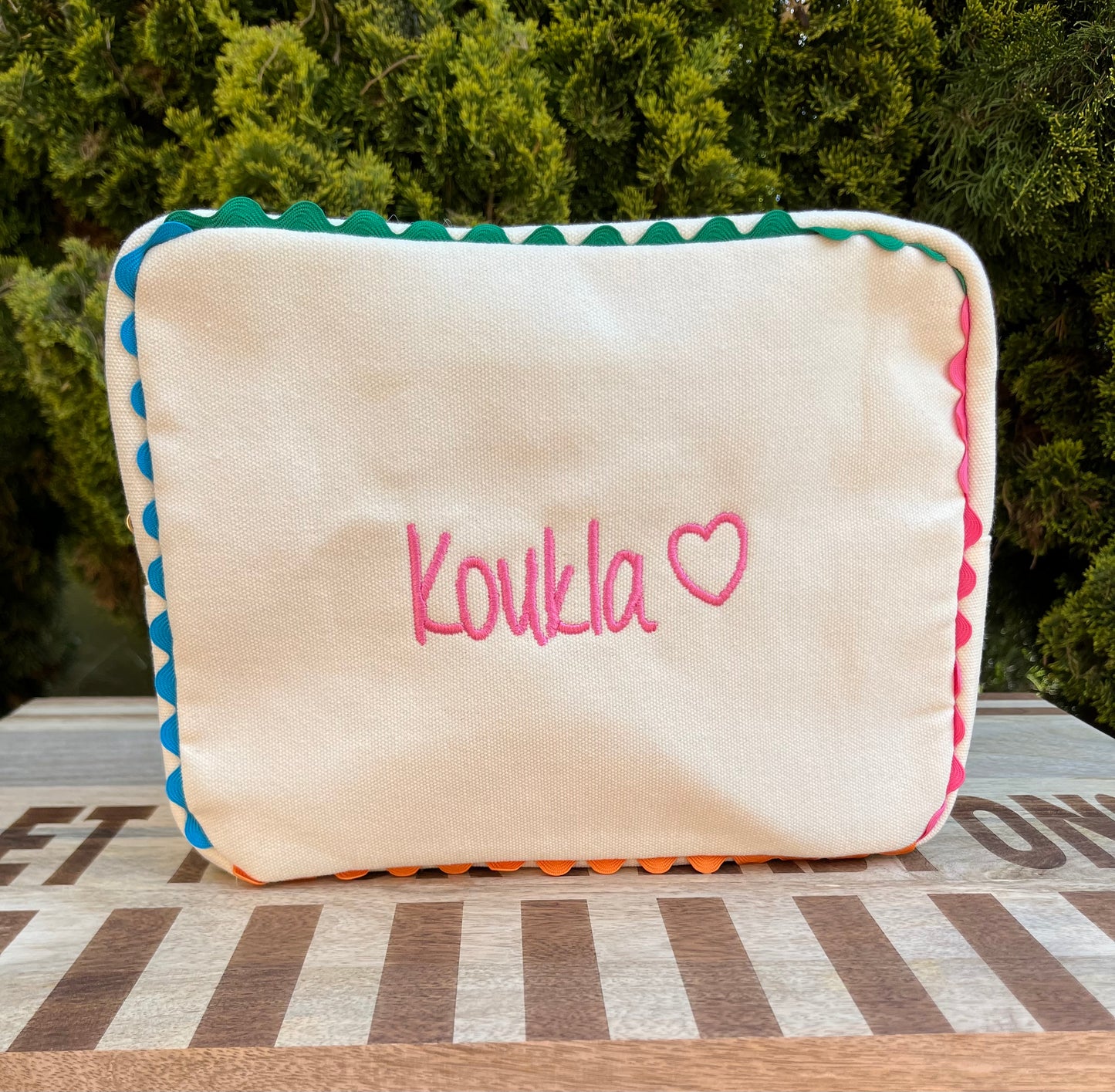 Embroidered canvas cosmetic bag with ric-rac border