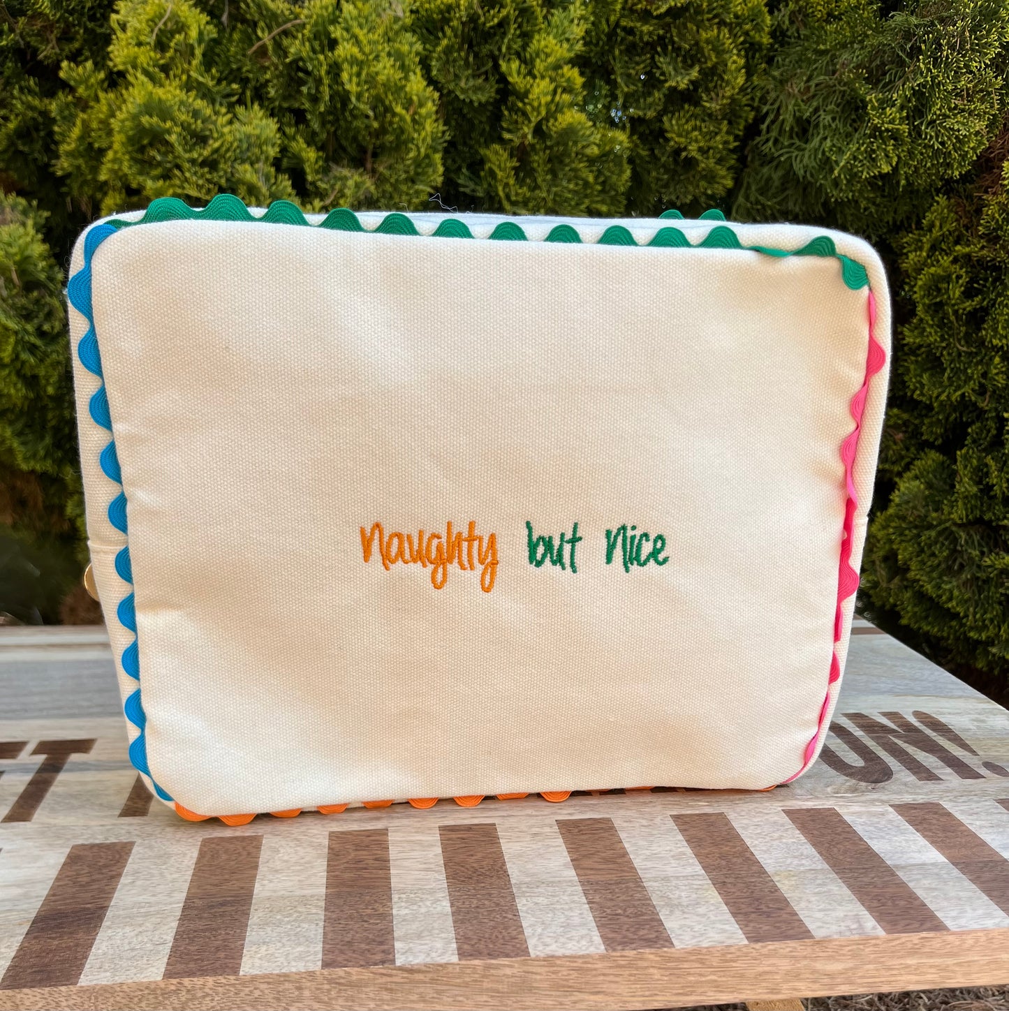 Embroidered canvas cosmetic bag with ric-rac border