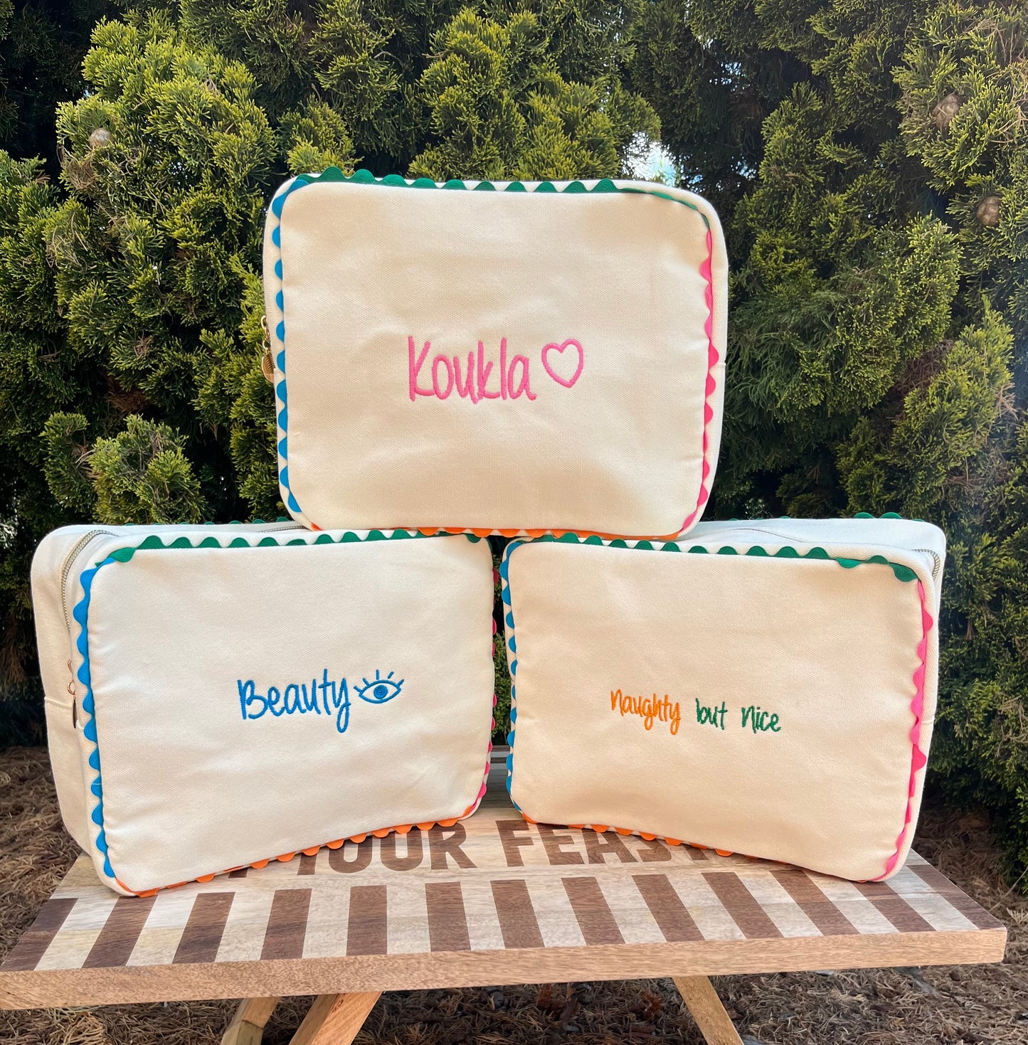 Embroidered canvas cosmetic bag with ric-rac border