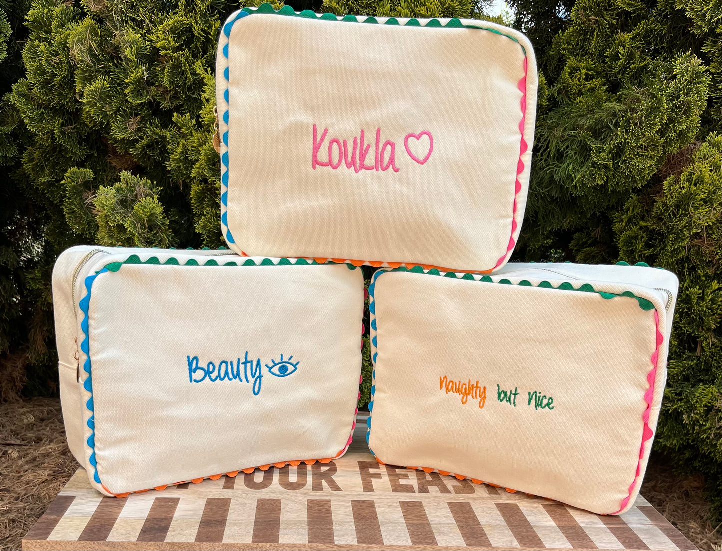 Embroidered canvas cosmetic bag with ric-rac border