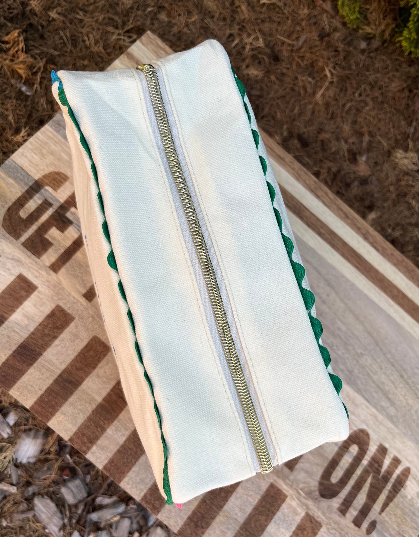 Embroidered canvas cosmetic bag with ric-rac border